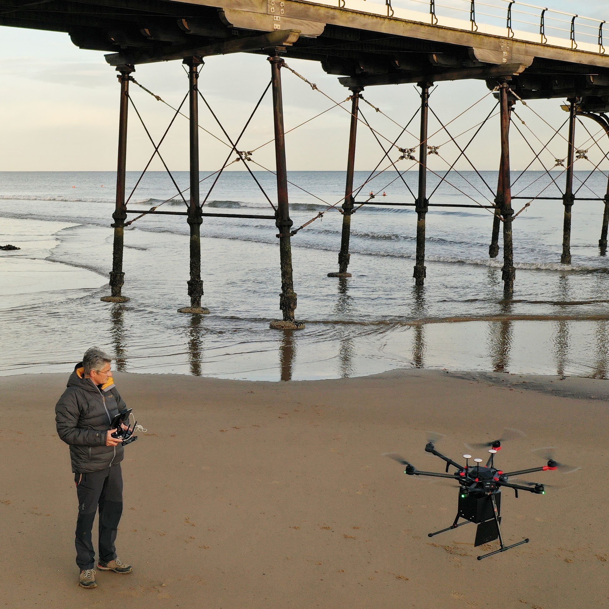 Man Flying a Drone on the Beach